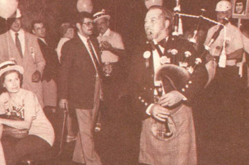 Man playing bagpipes at a convention