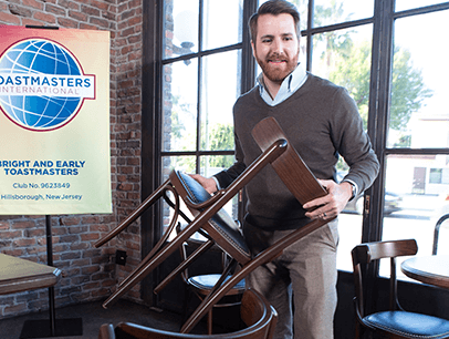 Man setting up chairs at meeting