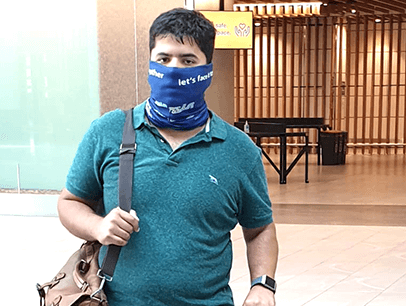 Man holding suitcase and bag at airport