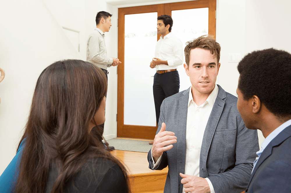 People speaking to each other at open house