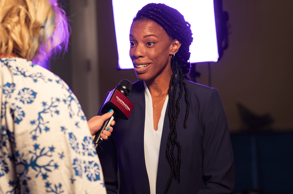 Woman being interviewed speaking into microphone