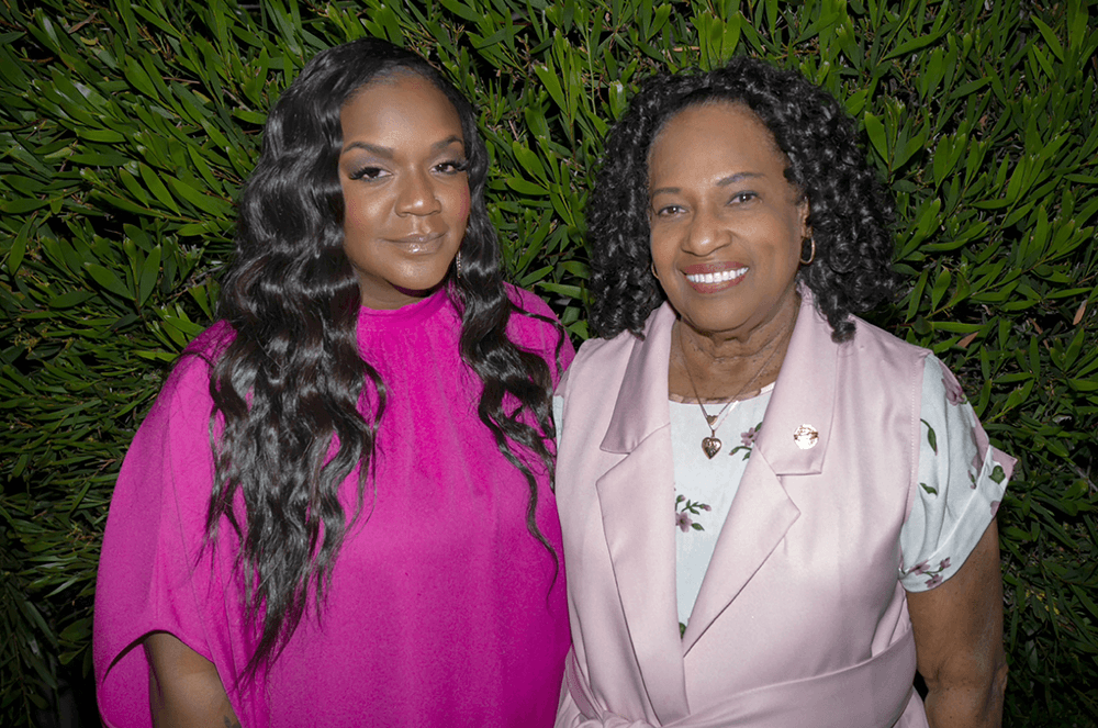 Mother and daughter posing together in different shades of pink clothing