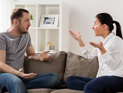 Man and woman talking on couch