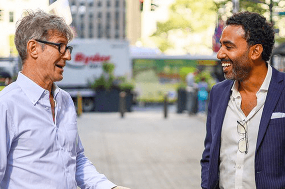 Two men speaking to each other on the street