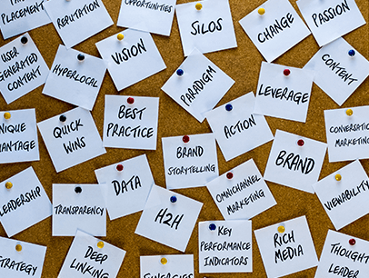 Jargon words pinned to cork board