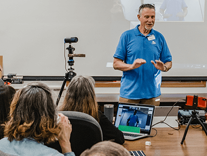 Man speaking at hybrid meeting