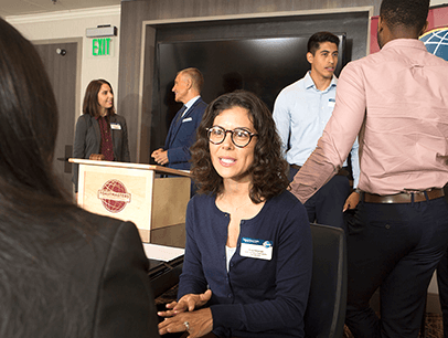 Woman speaking to someone at meeting