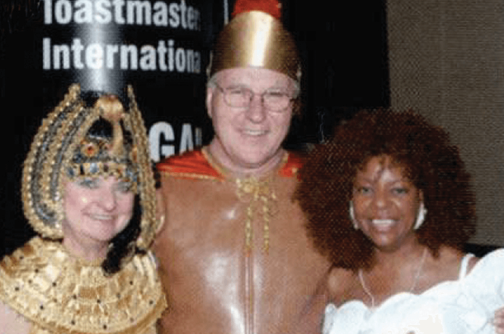 Man and two women posing in costumes