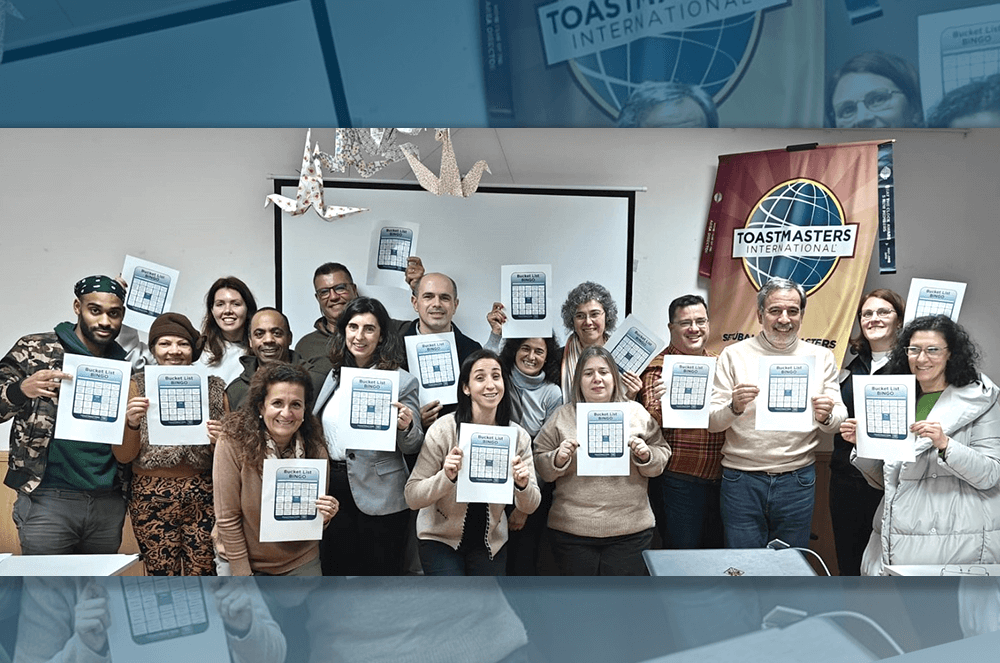 Group of people holding up bingo cards from the Toastmaster magazine January 2024 issue