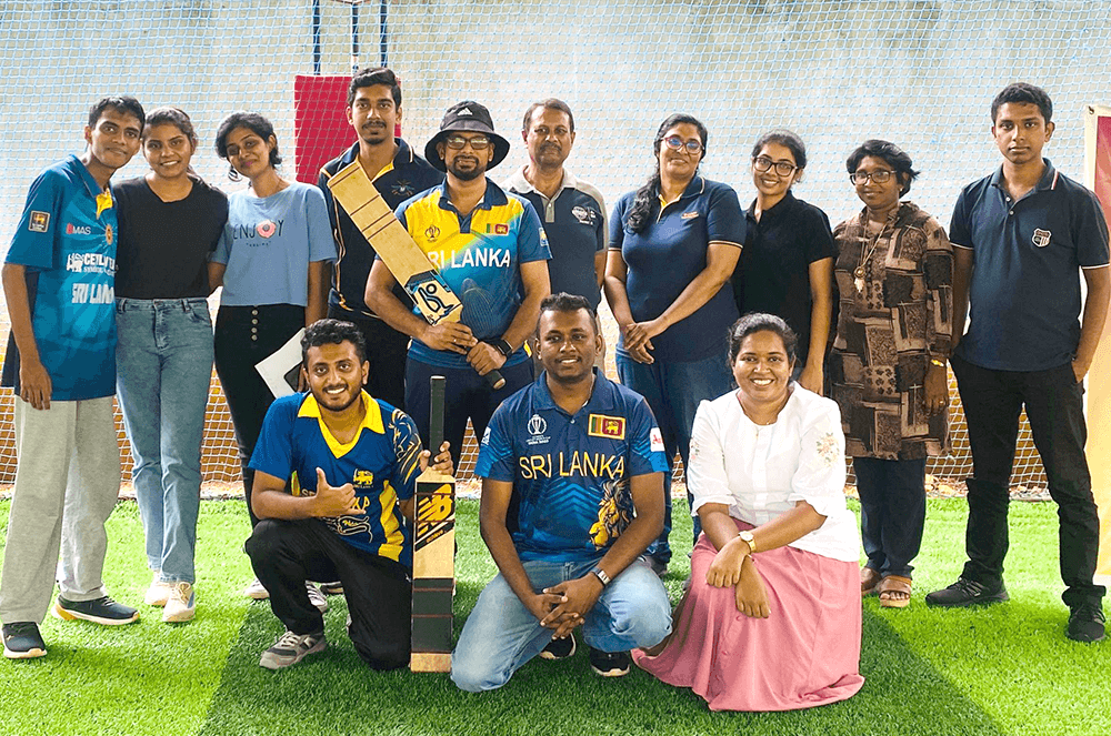 Group of people gathered at indoor cricket field