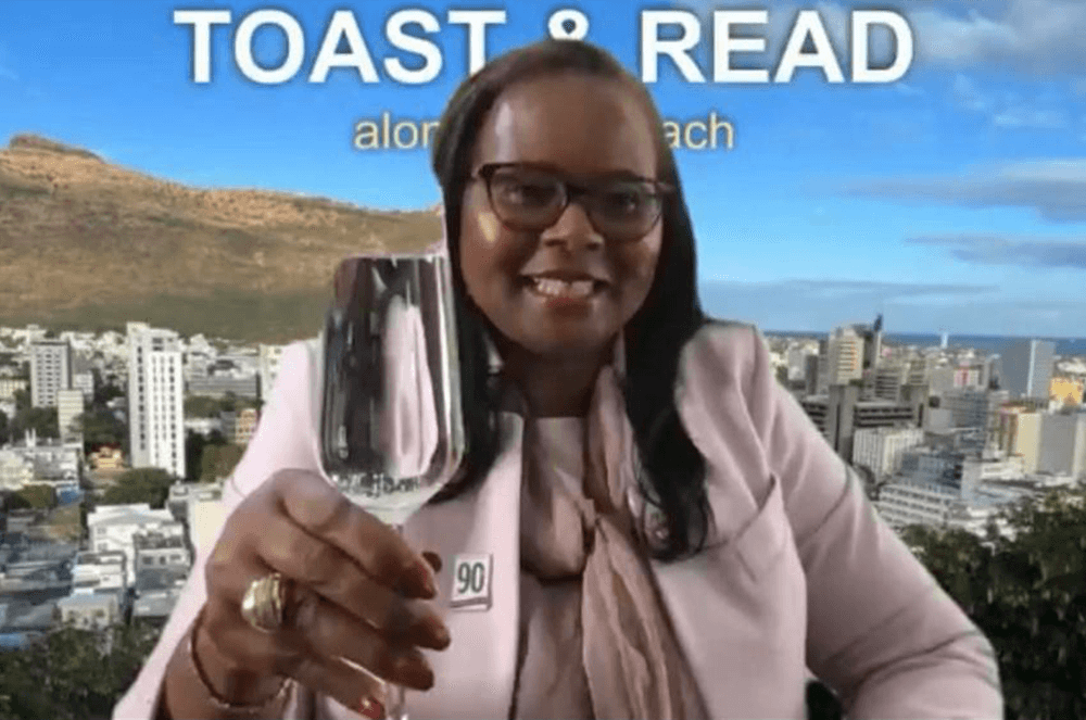 Woman in pink outfit holding up glass for a toast with digital background