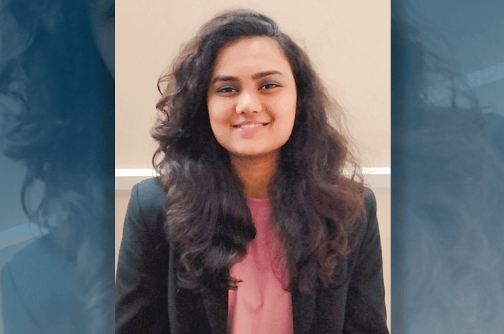 Woman in pink shirt and black jacket smiling