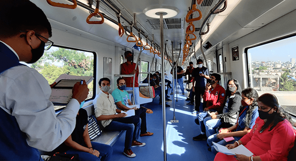 Toastmasters in Division N, District 98, host a meeting onboard the Mazi Metro in Nagpur, Maharashtra, India, in December 2020. The meeting space allowed for social distancing protocol during the COVID pandemic, and introduced a new metro system to nearby residents.