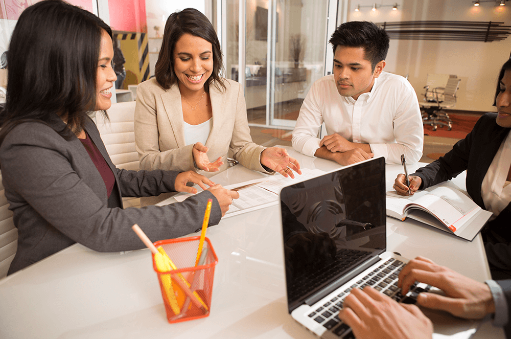 Group of coworkers at table with laptop