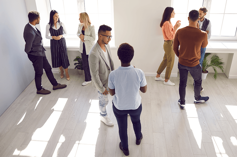 Men and women having casual conversations in a room 