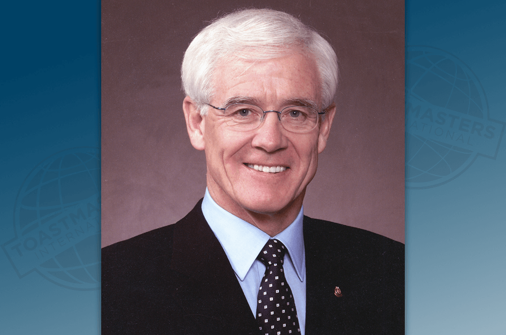 Chris Ford smiling in suit and decorated tie