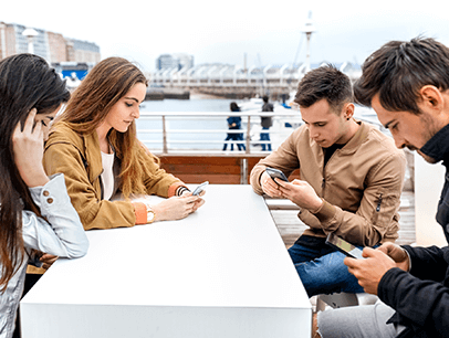 Friends at lunch on their phones