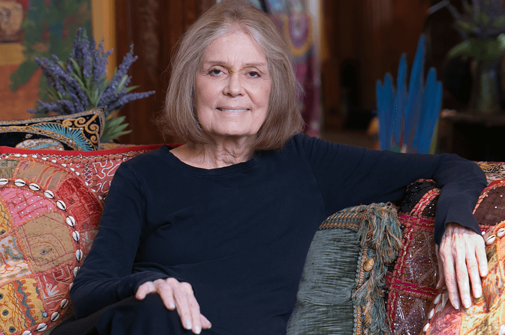 Woman in blue sweater sitting on couch