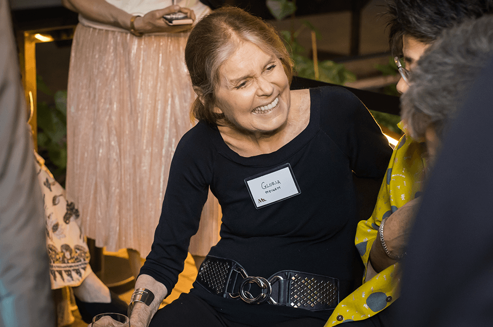 Woman wearing name tag while laughing with others