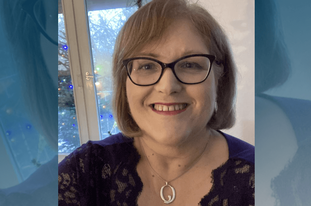 Woman smiling in dress with necklace 