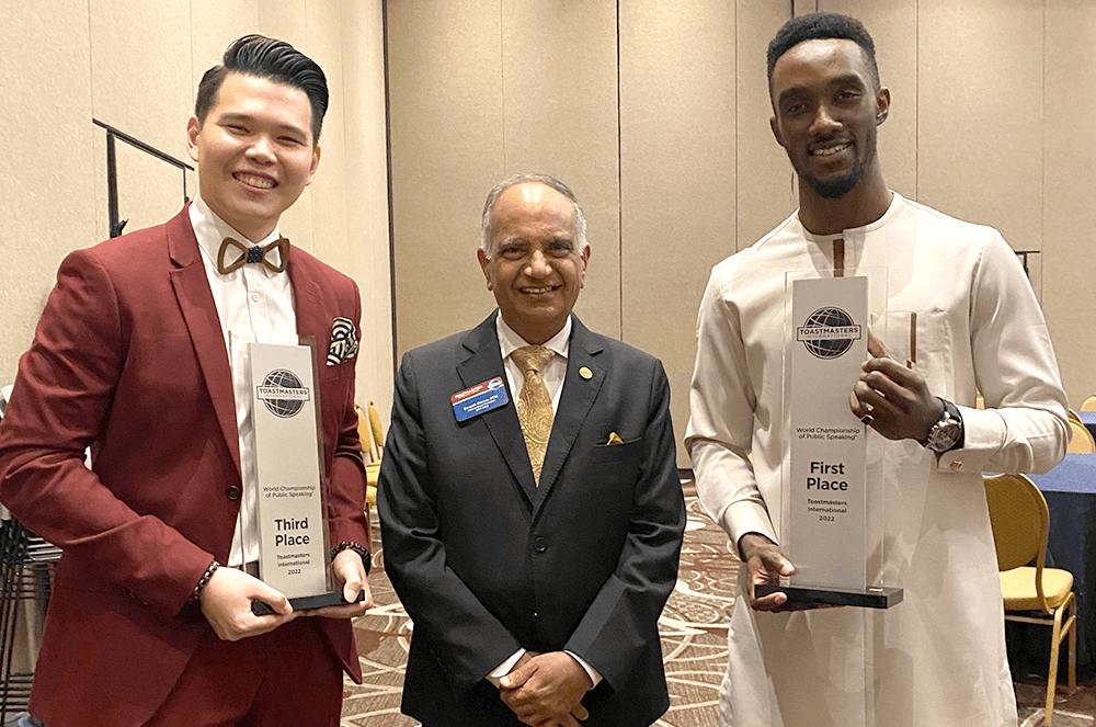 Three men posing after contest