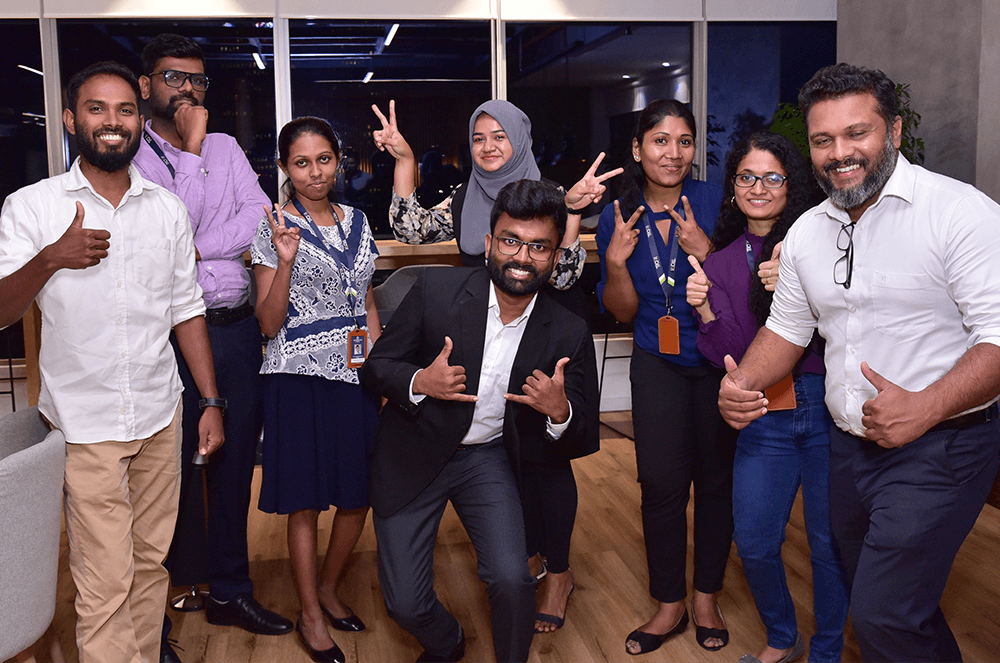 Group of people posing indoors making hand gestures