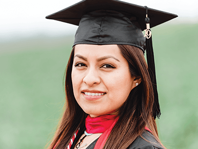 Woman posing in cap and gown