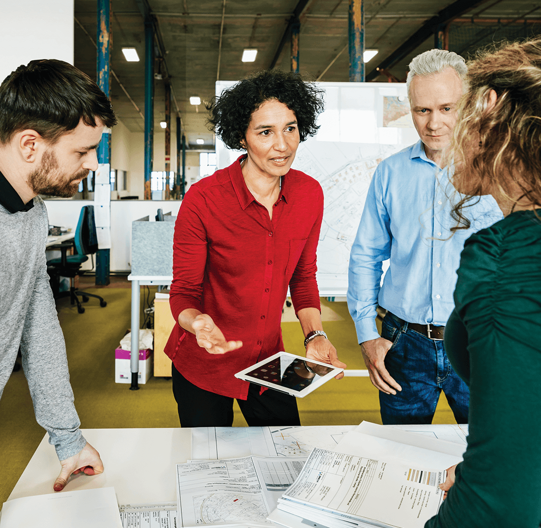 Two males and two females having discussion at work