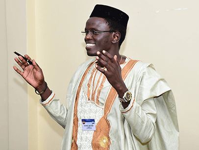 Dr. Stanley Aruyaru speaking with hand gestures