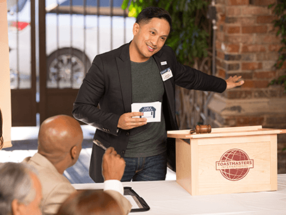 Man using hand gesture speaking at lectern