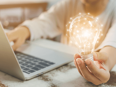 Image of person holding lightbulb lit up