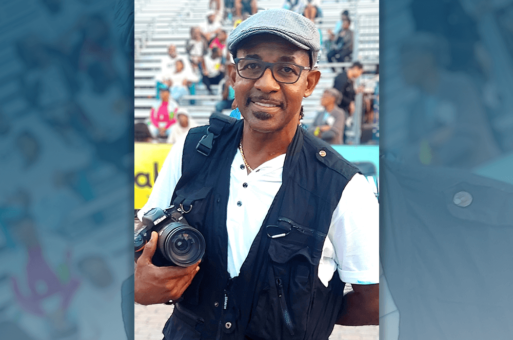 Longley, an avid photographer for 45 years, poses for someone else’s camera. 