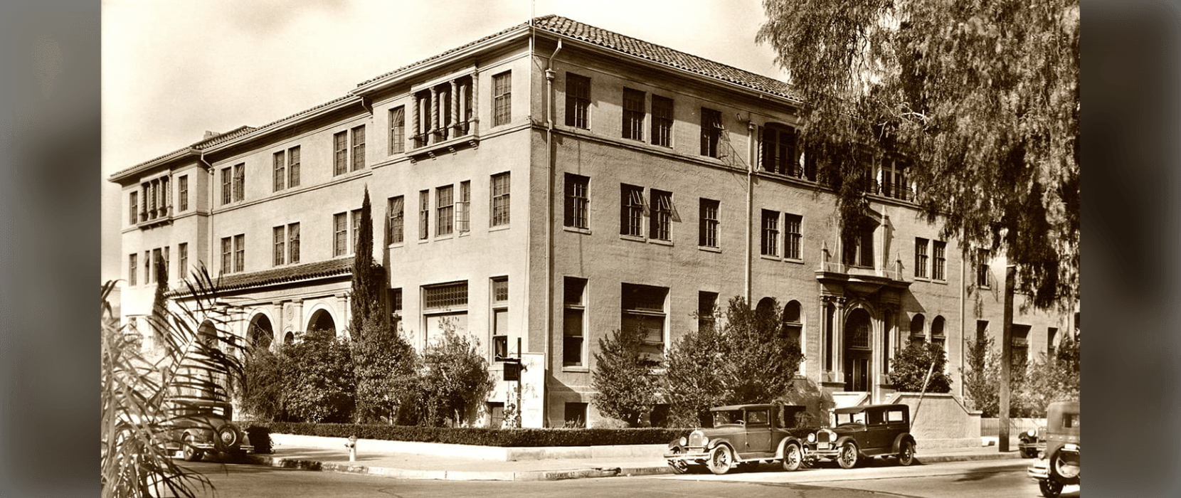 Black and white image of the outside of a three-story building